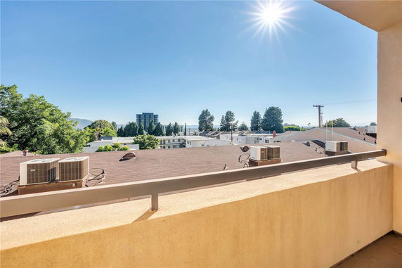 Rooftop view featuring air conditioning units on a flat roof.