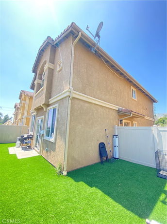 Side view of a two-story house with a satellite dish on the roof.