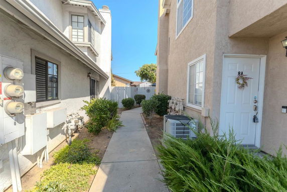 Pathway between two residential buildings with an entrance labeled 8A.