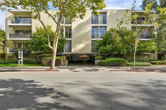 Front view of a multi-story apartment building with balconies.