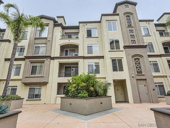 Front view of a multi-story residential building with balconies.