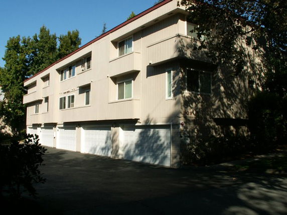 Front view of a two-story building with multiple garage doors.