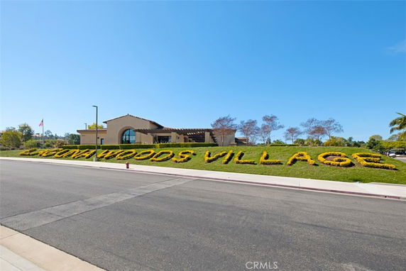 Front view of a building with a sign reading 'Laguna Woods Village'.