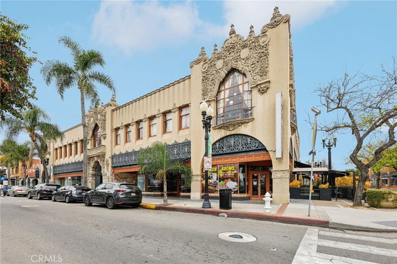Front view of a two-story building with ornate architectural details and large windows.