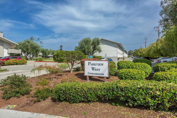 Front view of a condominium complex with multiple buildings.