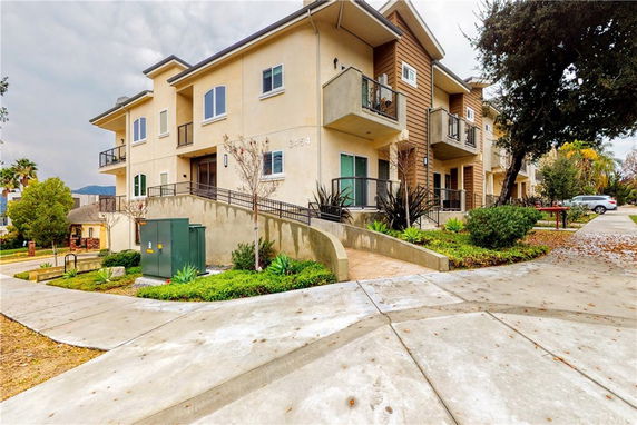 Front view of a modern two-story apartment building with multiple balconies.