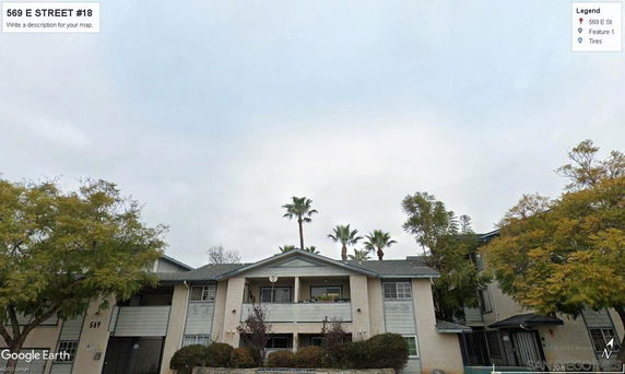 Front view of a two-story residential building with multiple windows and balconies.