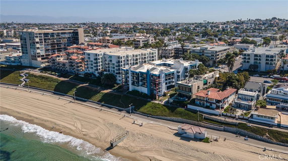 Aerial view of beachfront residential buildings near the coast.