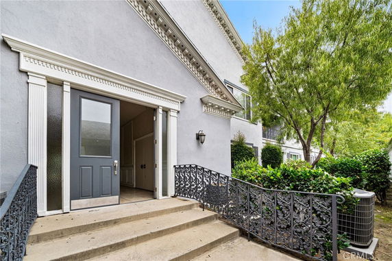 Front view of a house with decorative railing and entryway.
