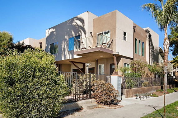 Front view of a modern two-story house with a balcony.