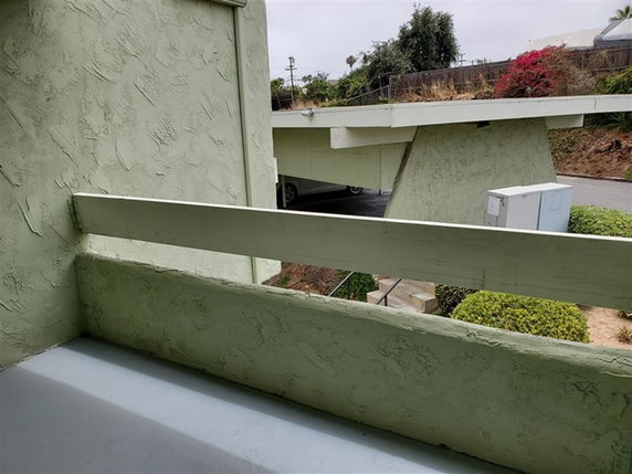 View from a building showing an overpass and vegetation in the surrounding area.