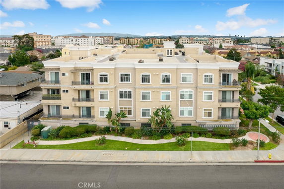 Front view of a multi-story residential building with balconies.