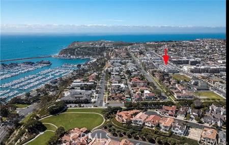 Panoramic view of a coastal residential area with houses and marina.