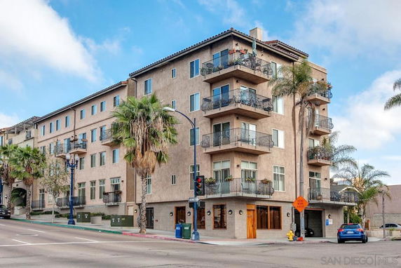 Front view of a multi-story residential building with balconies.