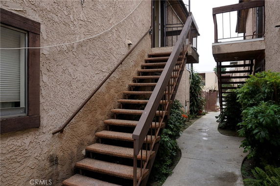 Exterior stairs leading to upper level apartments in a residential building.