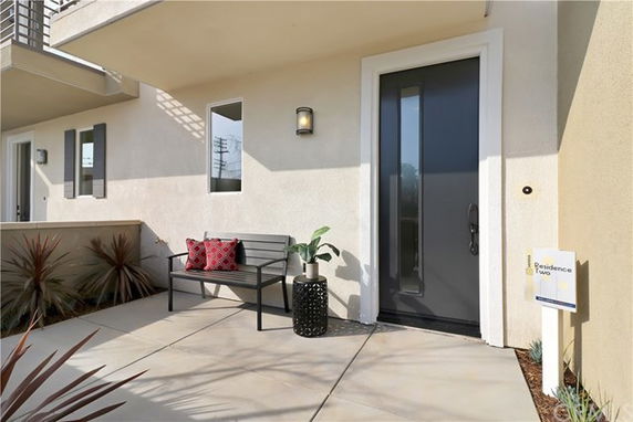 Front view of a house entrance with a black door and small porch area.