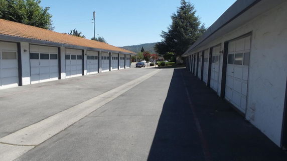 Outdoor parking area with multiple garage units.