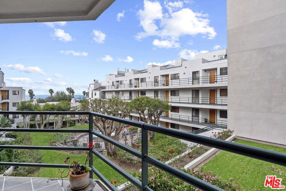 View of surrounding areas with multi-story apartment buildings and landscaped gardens.
