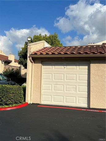 Front view of a building with a garage and tiled roof