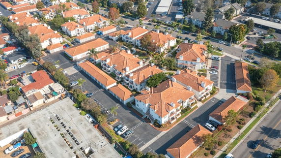 Aerial view of a residential area with multiple houses and parking spaces.