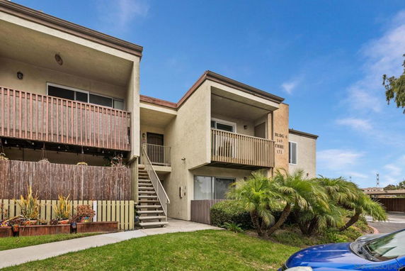 Front view of a two-story apartment building with balconies.