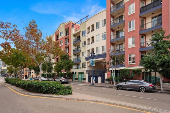 Front view of a multi-story residential building with balconies.