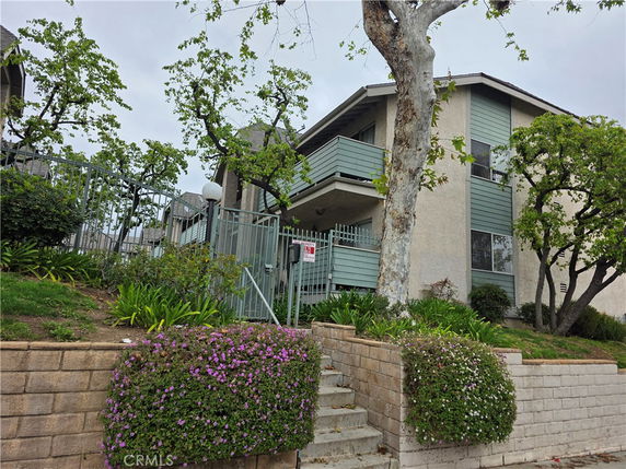 Front view of a multi-story residential building with balconies.