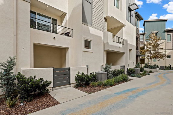 Front view of a multi-story residential building with balconies.