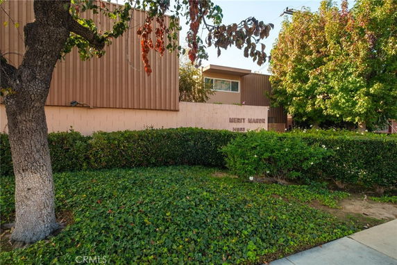 Front view of a building with a sign reading 'Merit Manor'.