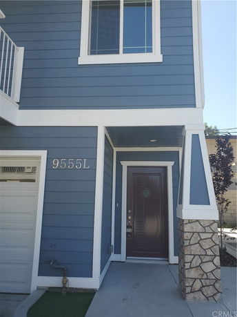 Front view of a house with a blue facade and a single door entry.