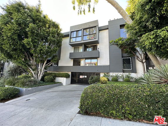 Front view of a multi-story residential building with modern design.