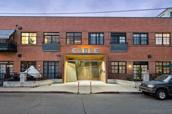 Front view of a two-story building with a brick facade and multiple windows.