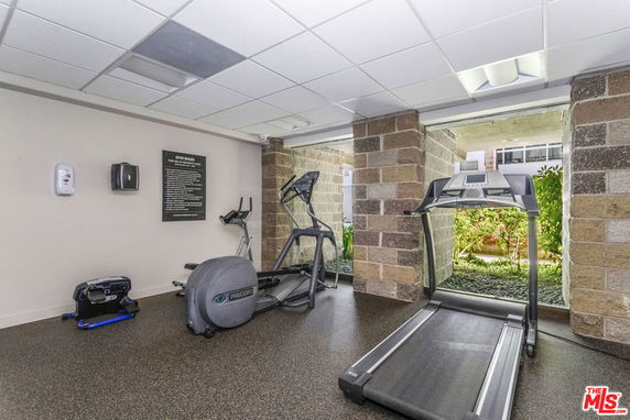 Indoor gym area with exercise equipment including a treadmill and elliptical machine.