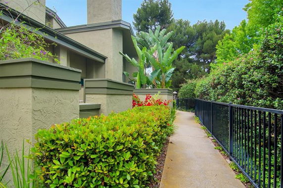 Front view of a house with a pathway and landscaped garden.