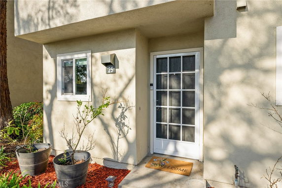 Front view of a house entrance with a white door and a small window.