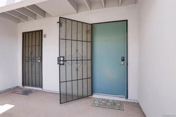 Front view of a home entrance with two doors and security screens.