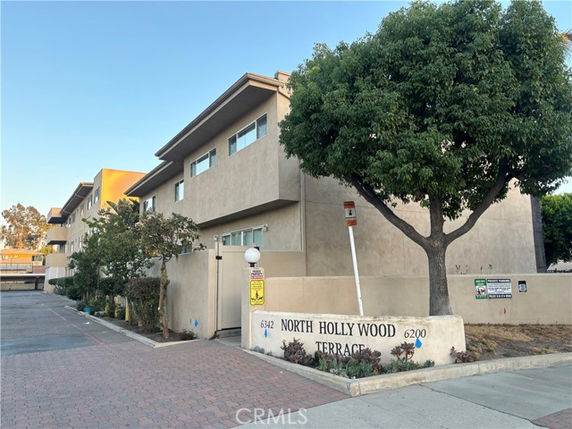 Front view of a multi-story building with a sign reading 'North Hollywood Terrace'.