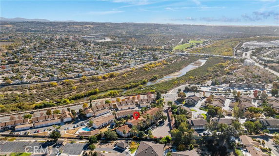 Wide-angle view of residential area with houses, roads, and landscape.