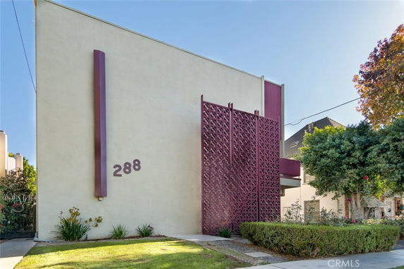 Front view of a modern building with decorative panels and address number 288.