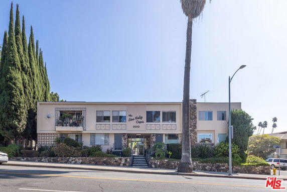 Front view of a two-story apartment building with a central entrance.