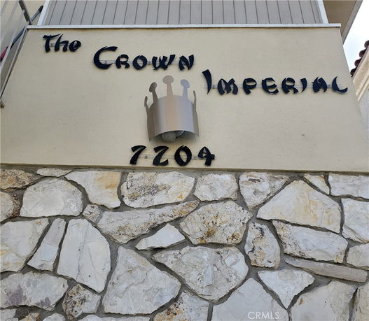 Exterior section of a building with a sign reading 'The Crown Imperial' and the number 7204.