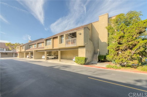 Front view of a two-story building with covered parking.