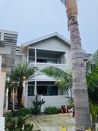 Front view of a two-story house with balconies.