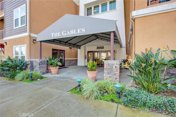Front view of a building entrance with an awning labeled 'The Gables'.
