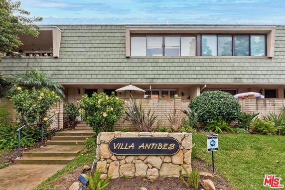 Front view of a building with a stone sign labeled 'Villa Antibes' and a sloped roof.