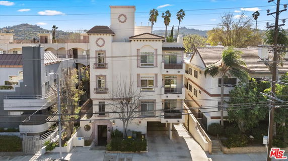Front view of a multi-story residential building with balconies.