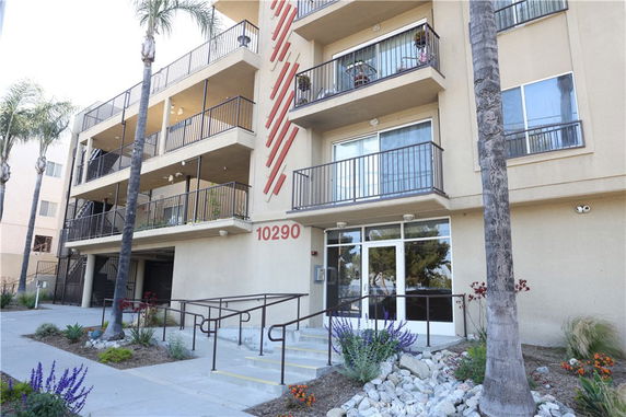 Front view of a multi-story residential building with balconies.