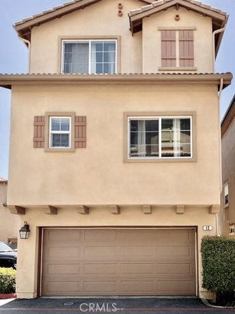 Front view of a two-story house with a garage.