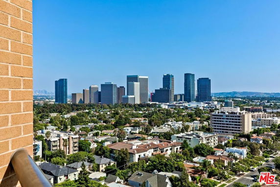 Panoramic view of city skyline with residential and commercial buildings.