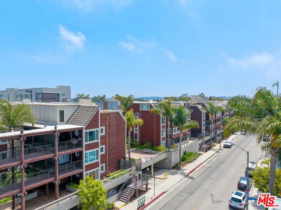 Front view of a multi-story residential building with balconies.